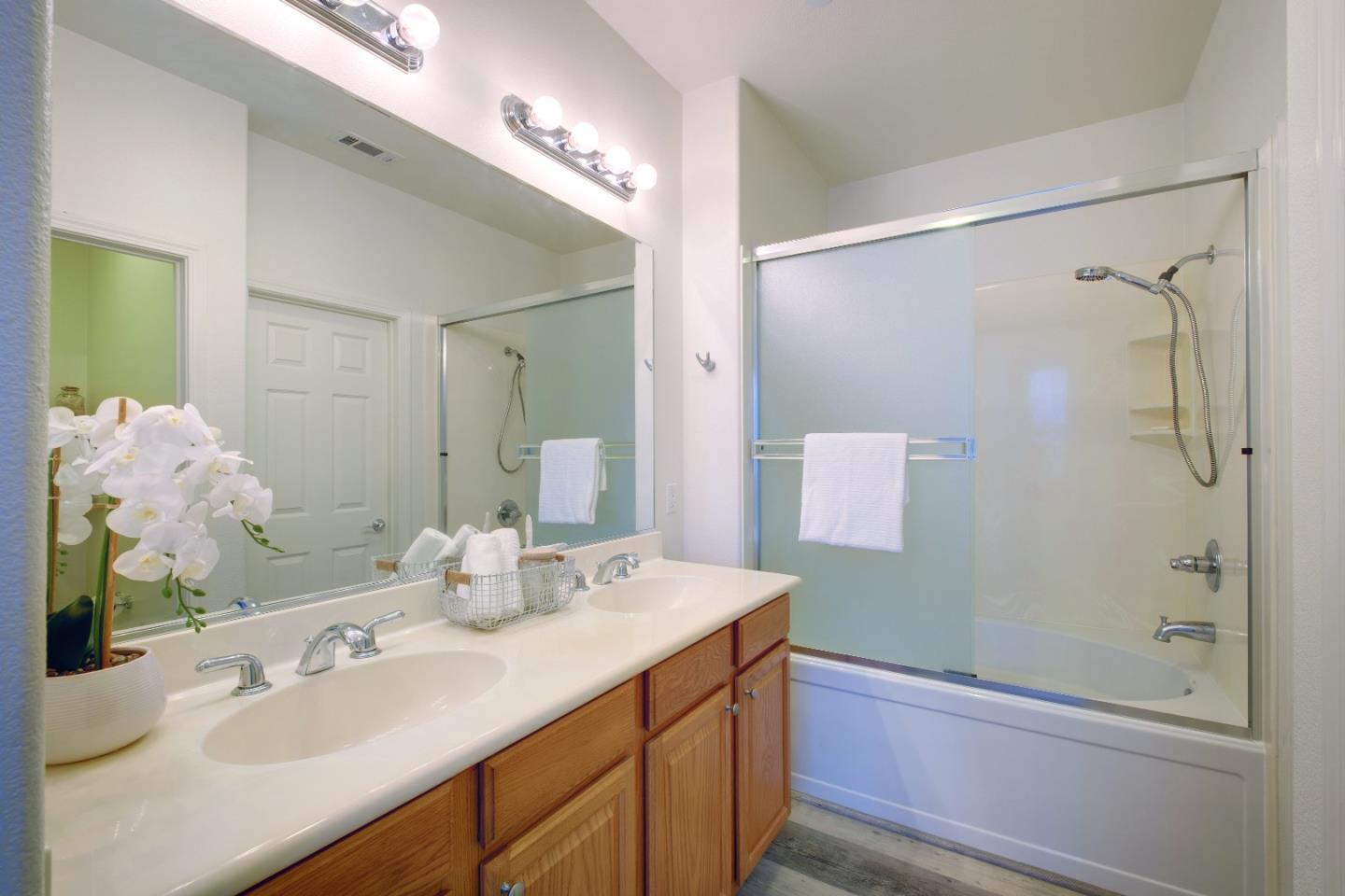 738 Claridad Loop Milpitas, CA 95035 - Photo 25 of 53 a bathroom with a sink double vanity granite tub shower and a mirror