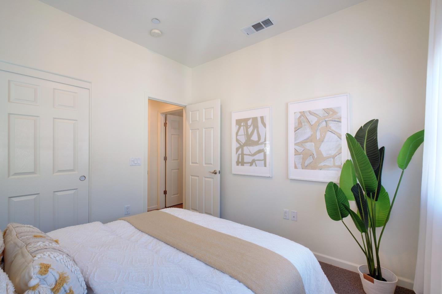 738 Claridad Loop Milpitas, CA 95035 - Photo 27 of 53 a bedroom with bed and a potted plant