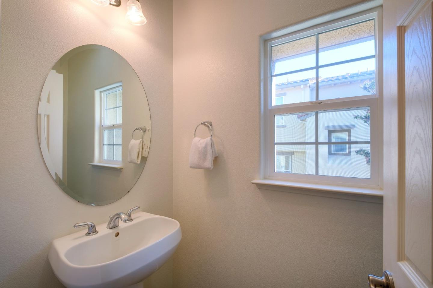 738 Claridad Loop Milpitas, CA 95035 - Photo 31 of 53 a bathroom with a sink a mirror and a window