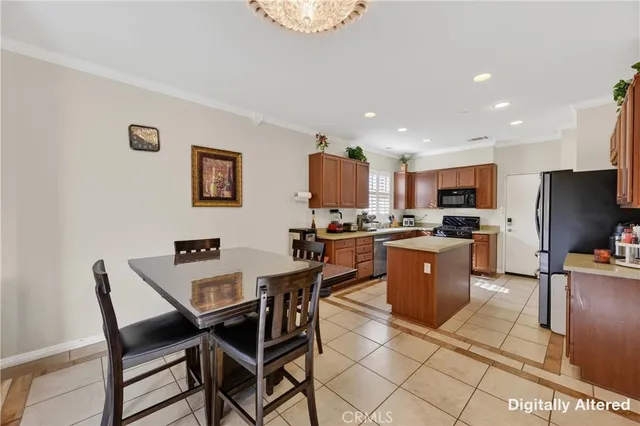 a kitchen with a dining table chairs and a refrigerator