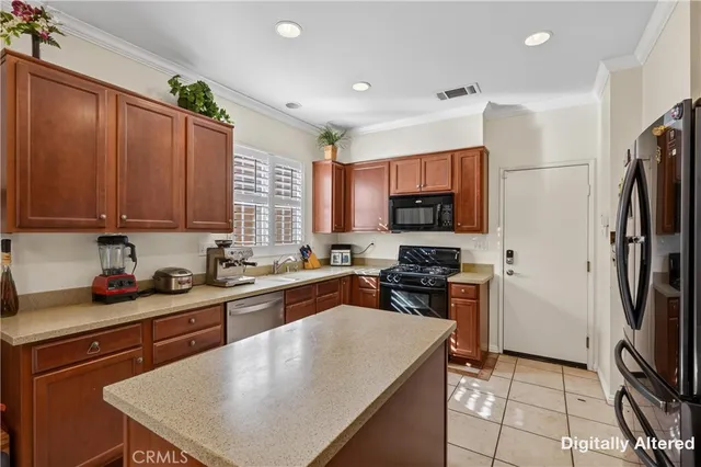a kitchen with stainless steel appliances a stove refrigerator sink and microwave