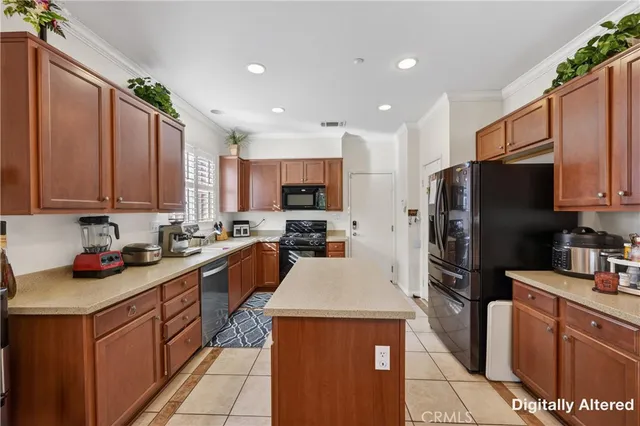 a kitchen with stainless steel appliances a refrigerator sink stove microwave and cabinets