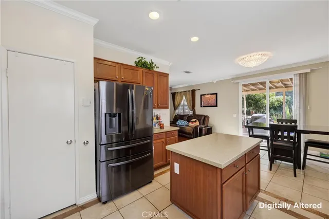 a kitchen with a refrigerator a table and chairs