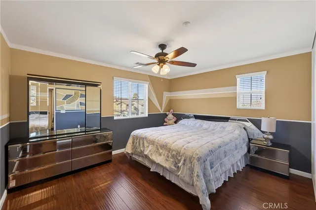 a bedroom with a bed and a ceiling fan