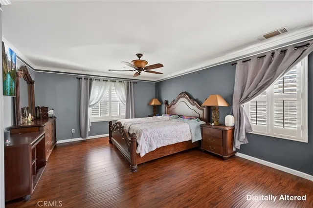 a bedroom with a bed and a large mirror with a projector