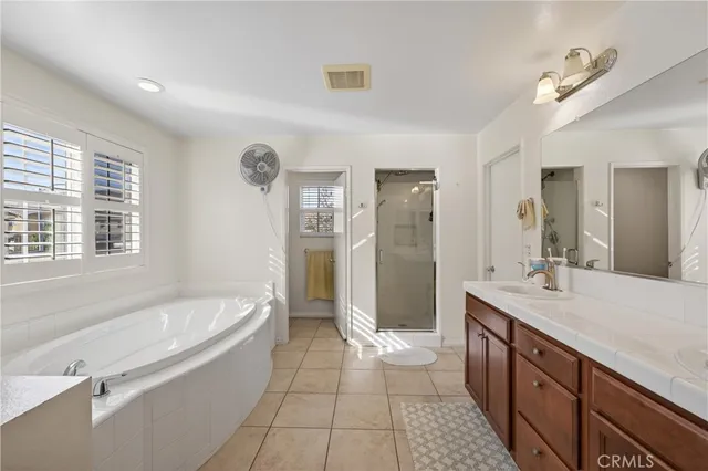 a white bath tub sitting in a bathroom next to a window