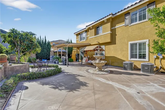 a view of a patio with plants and chairs potted plants
