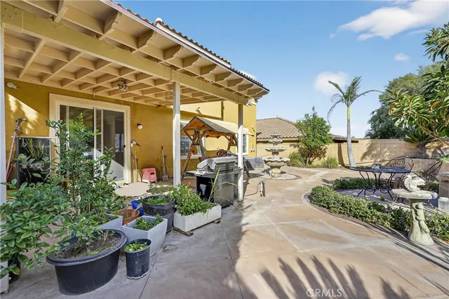a building outdoor space with patio furniture and potted plants