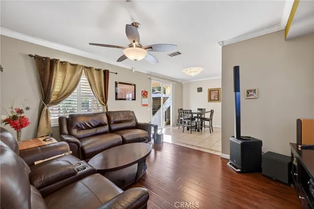 a living room with furniture a wooden floor and a window
