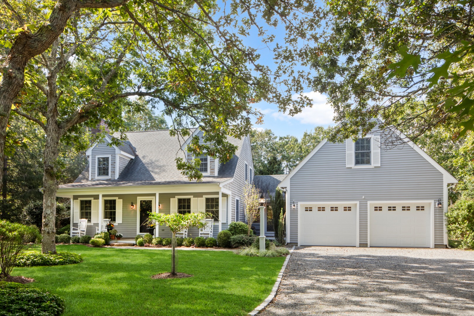 a front view of a house with a garden