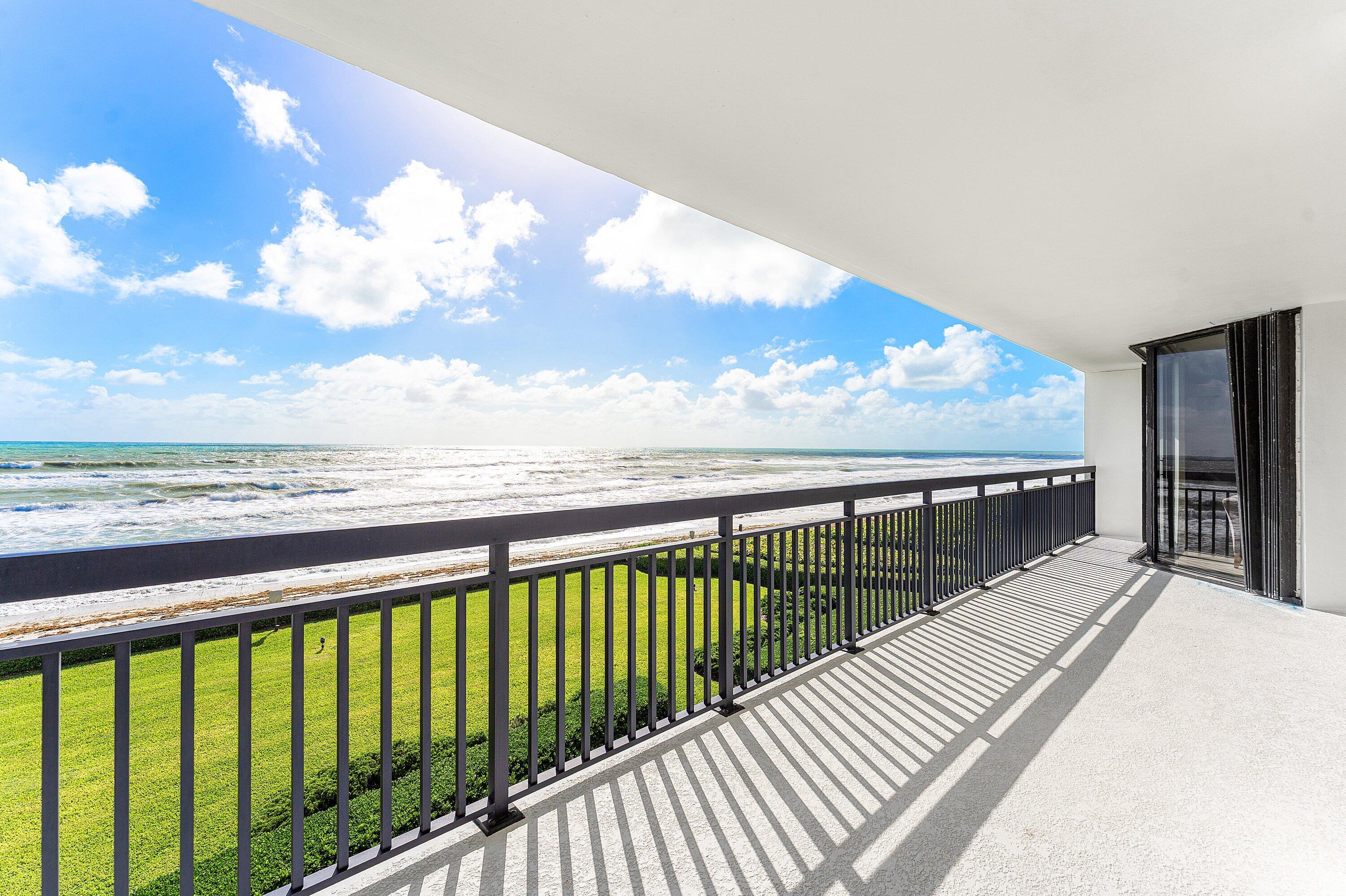 a view of balcony with wooden floor and fence