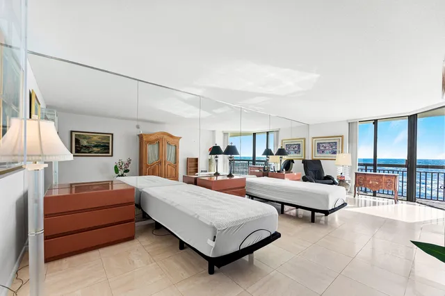 a bedroom with furniture and a large window