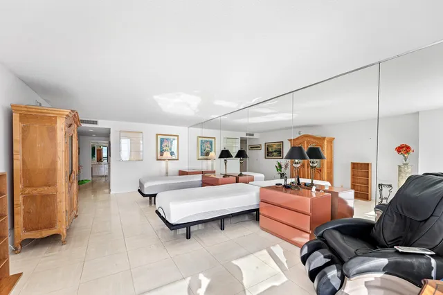 a bedroom with furniture and a large window