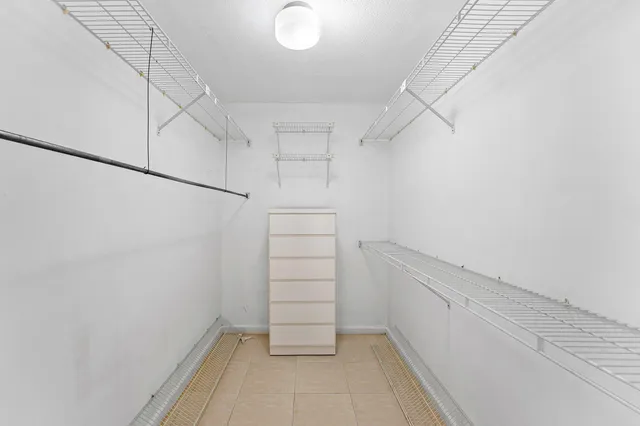 a view of walk in closet with empty racks