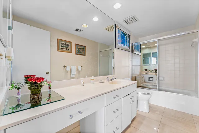 a spacious bathroom with a sink mirror and vanity