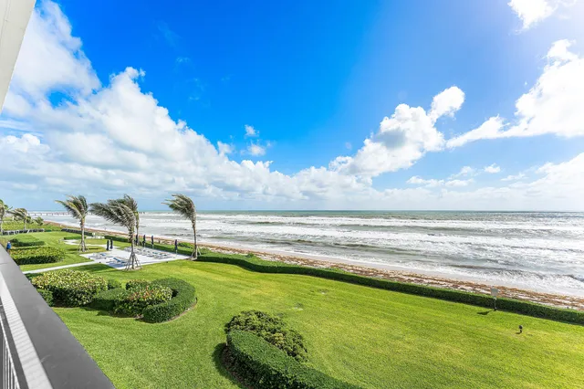 a view of a swimming pool with an outdoor seating and a yard