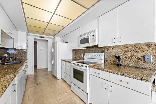 a kitchen with granite countertop cabinets and steel stainless steel appliances