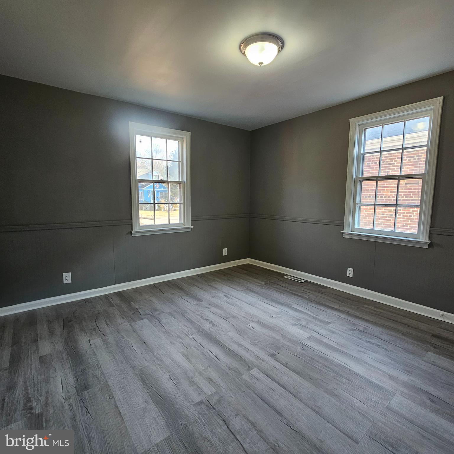 41 Churchtown Road Pennsville, NJ 08070 - Photo 14 of 16 an empty room with wooden floor and windows