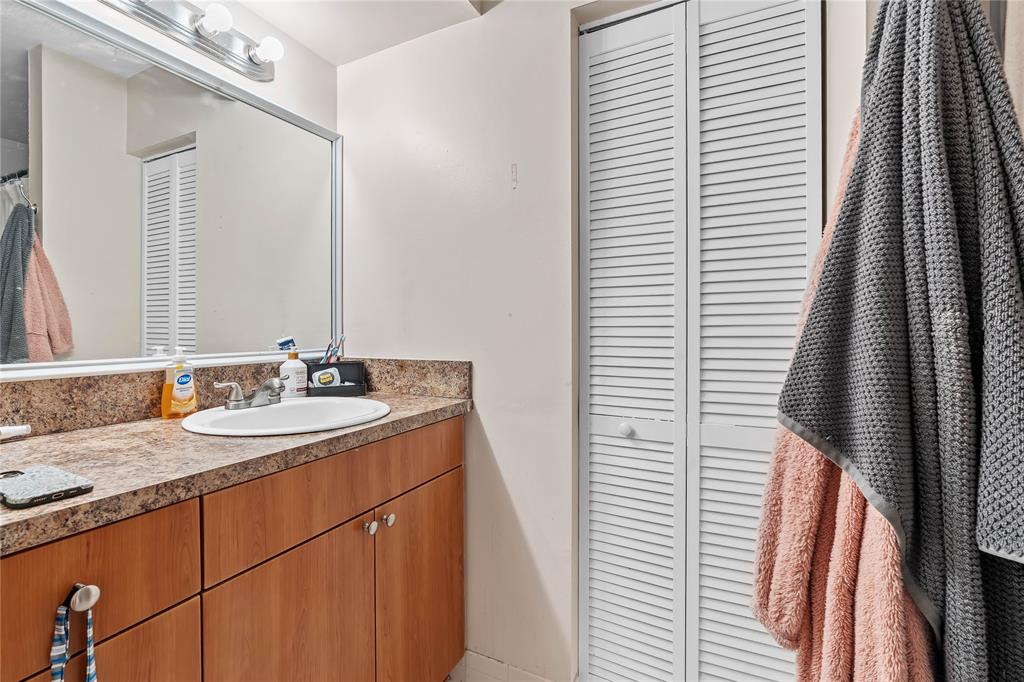 4840 North State Road 7, Unit 6304 Pompano Beach, FL 33073 - Photo 11 of 18 a bathroom with a sink and a mirror