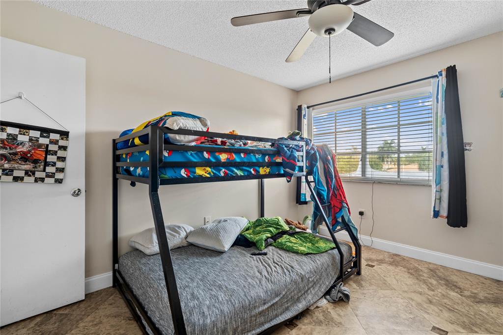 4840 North State Road 7, Unit 6304 Pompano Beach, FL 33073 - Photo 12 of 18 a bedroom with bed and a window