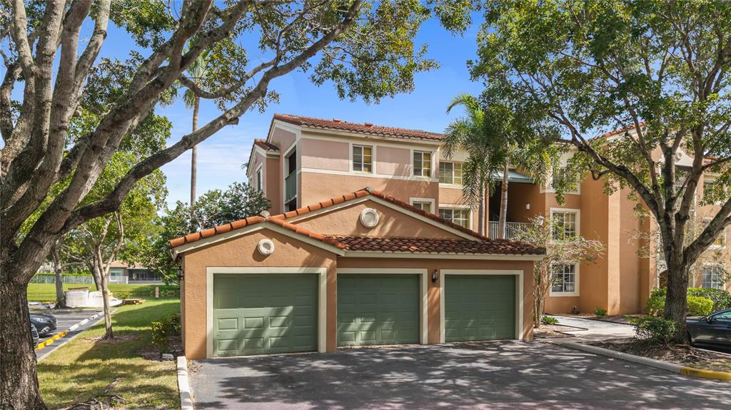 4840 North State Road 7, Unit 6304 Pompano Beach, FL 33073 - Photo 5 of 18 a front view of a house with a garden