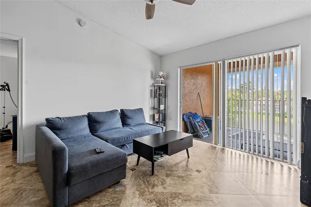 a living room with furniture and a dining area with kitchen view