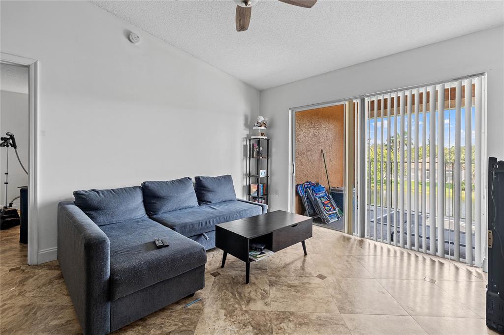 4840 North State Road 7, Unit 6304 Pompano Beach, FL 33073 - Photo 7 of 18 a living room with furniture and a window
