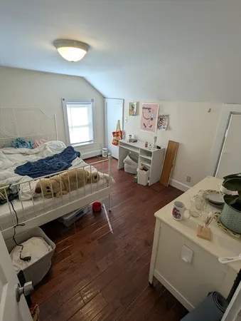 a bedroom with furniture and a window