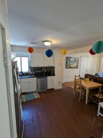 a kitchen with wooden floors and a sink