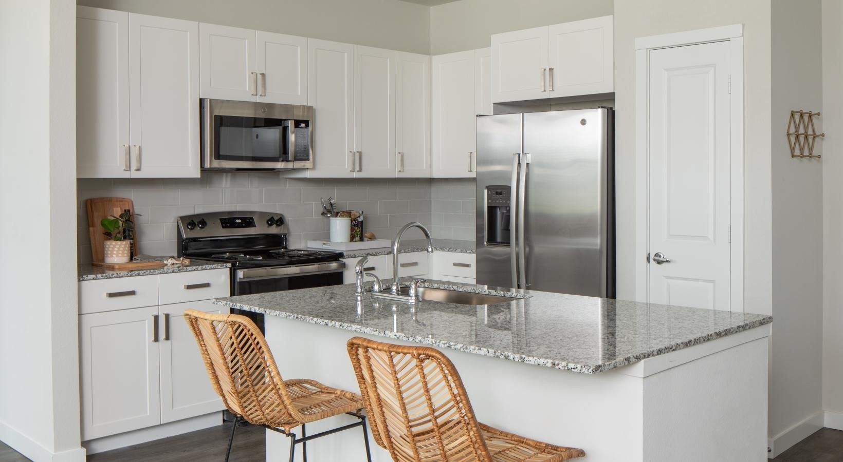 12111 South Main Street, Unit 3306 Houston, TX 77035 - Photo 4 of 24 a kitchen with stainless steel appliances granite countertop a sink a stove and a refrigerator