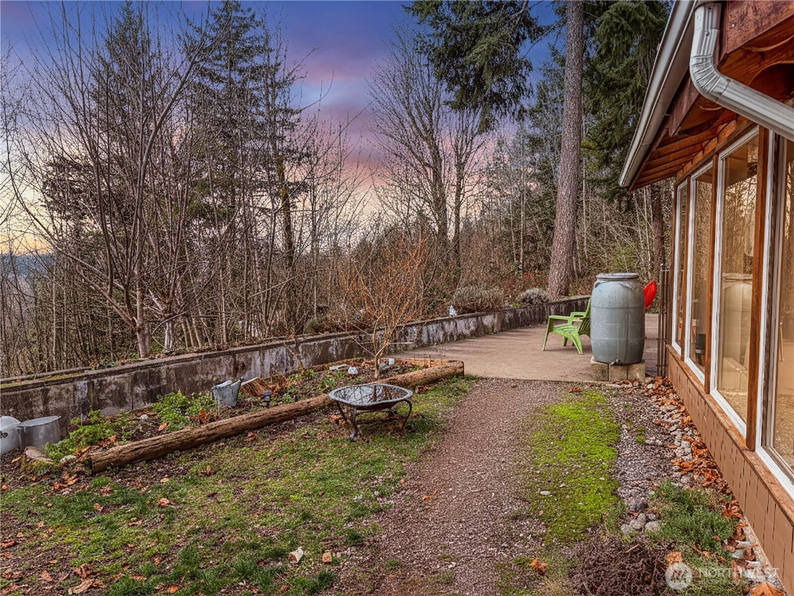 5450 Reese Hill Road Sumas, WA 98295 - Photo 26 of 33 a view of a chair and fire pit in the backyard with large trees