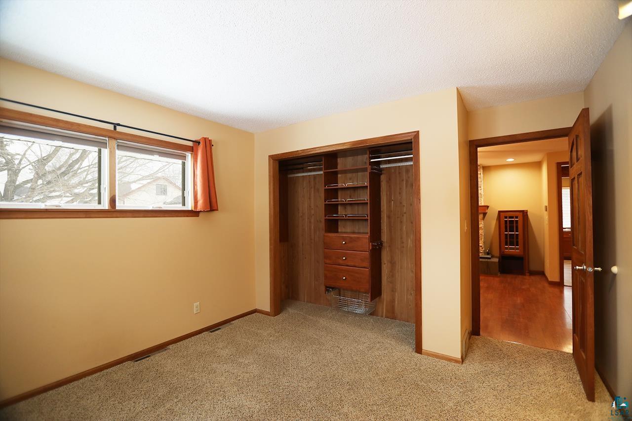 811 7th Street North Virginia, MN 55792 - Photo 14 of 37 Unfurnished bedroom featuring light colored carpet, a closet, and a textured ceiling