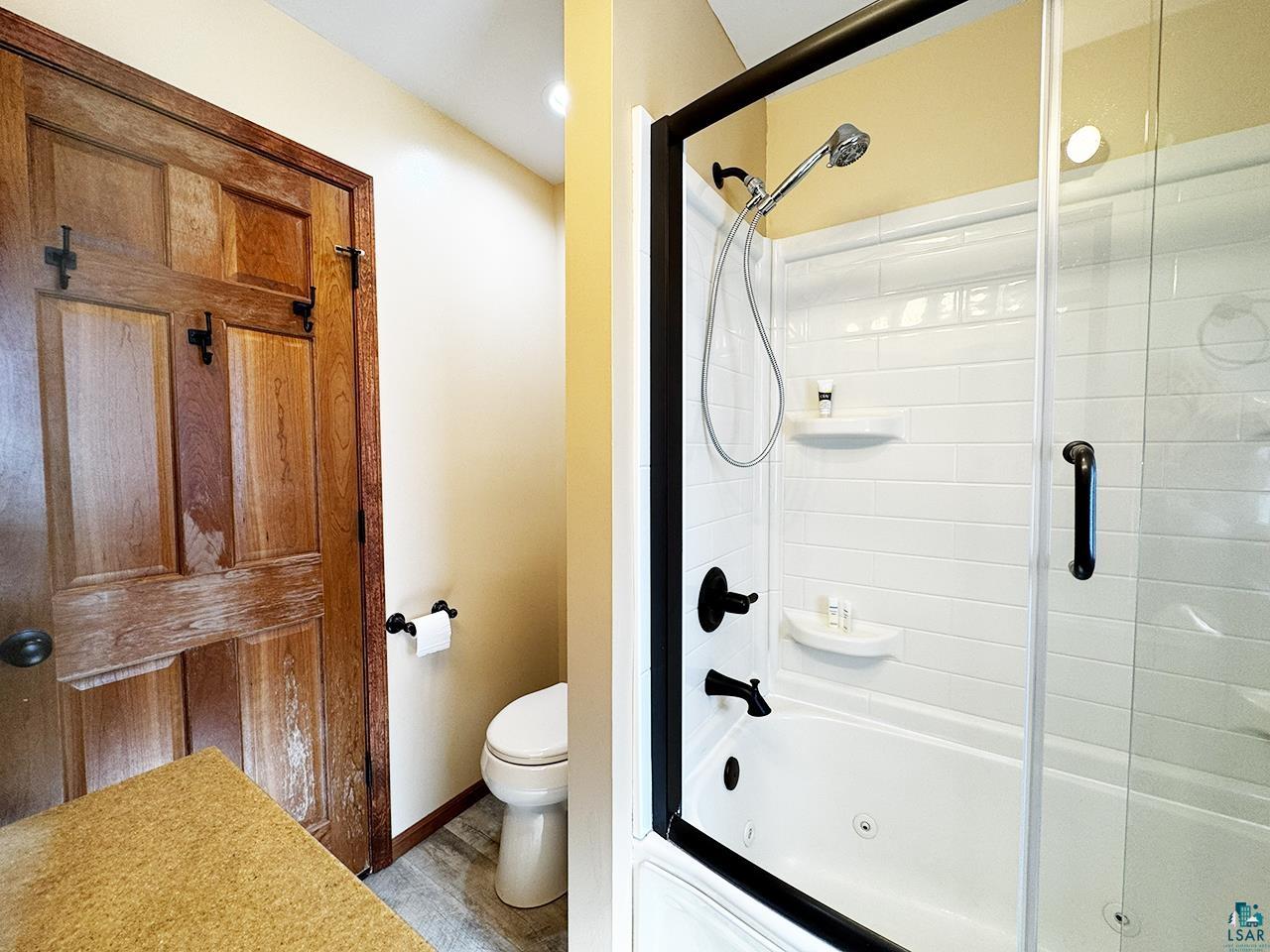811 7th Street North Virginia, MN 55792 - Photo 19 of 37 Bathroom featuring toilet and enclosed tub / shower combo