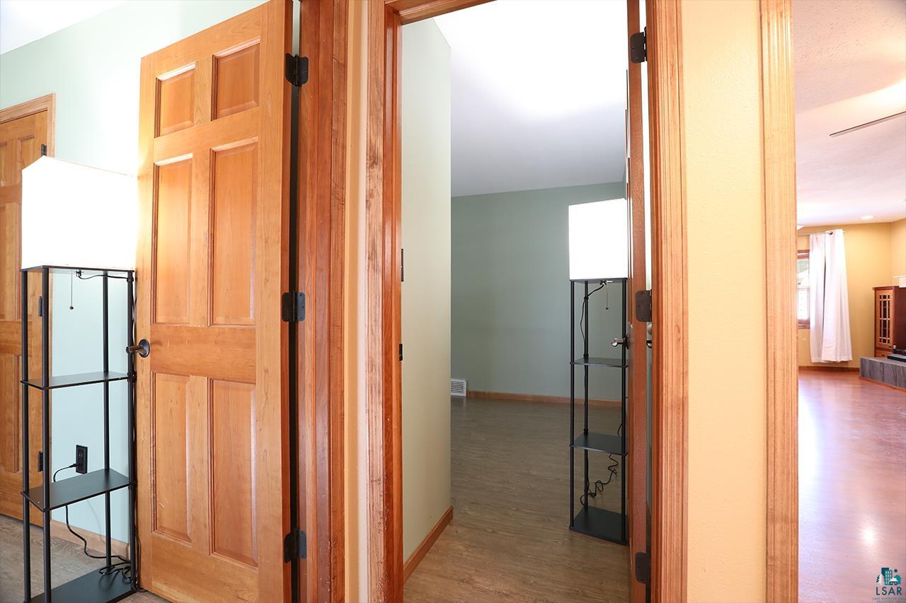 811 7th Street North Virginia, MN 55792 - Photo 25 of 37 Corridor featuring light wood-style flooring and baseboards