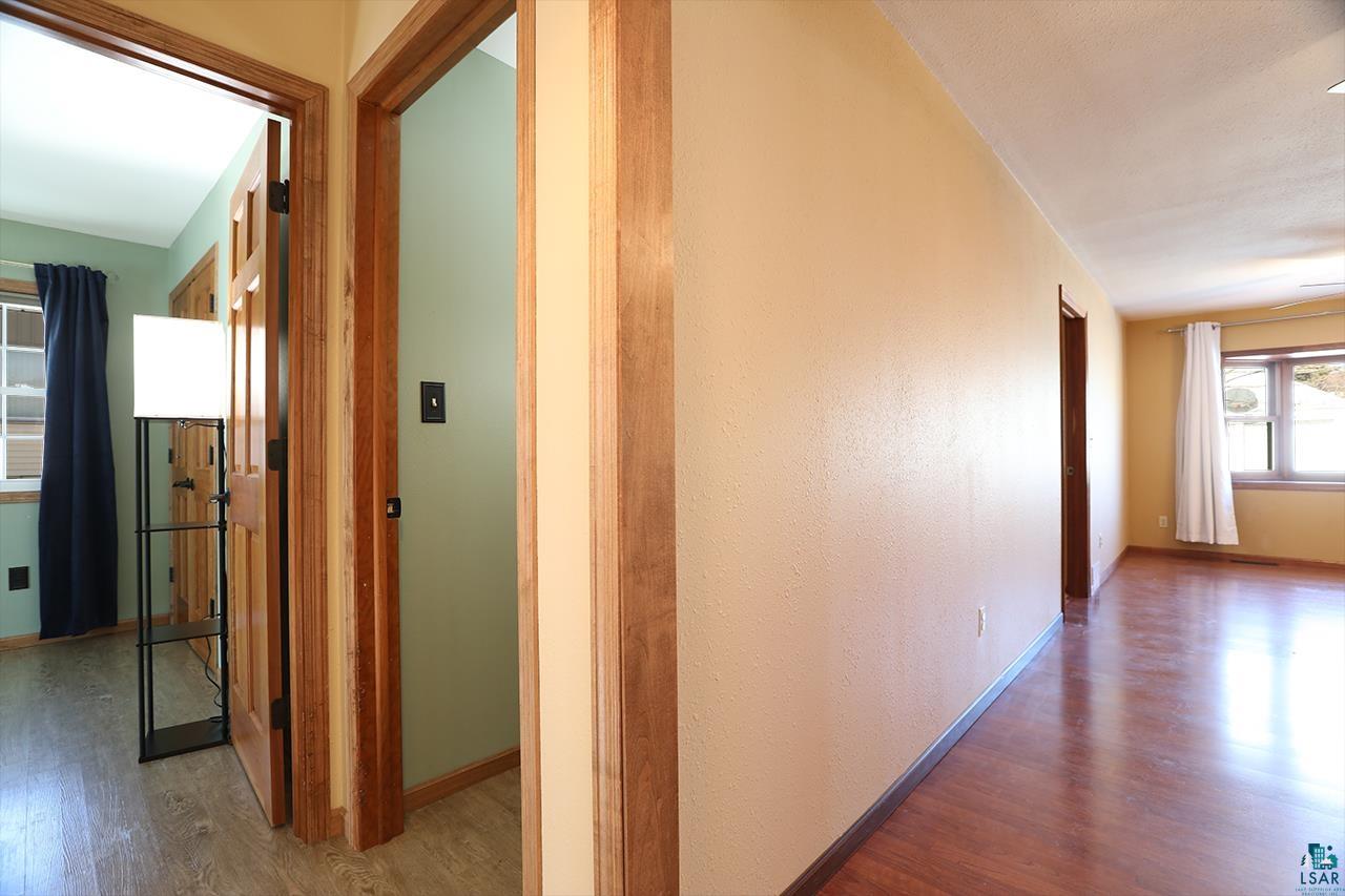 811 7th Street North Virginia, MN 55792 - Photo 26 of 37 Corridor featuring wood finished floors and baseboards