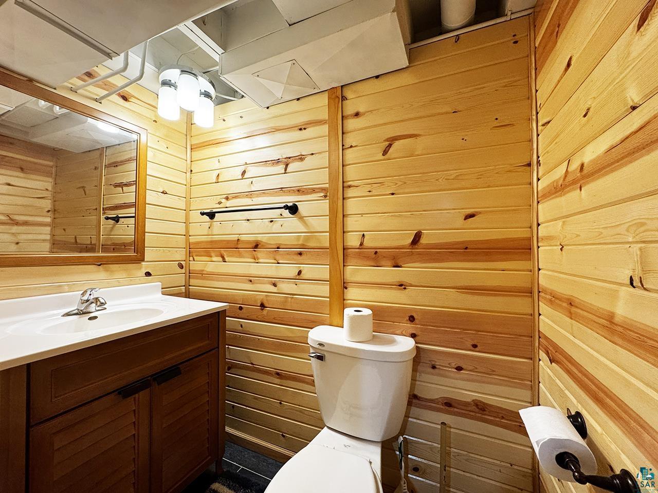 811 7th Street North Virginia, MN 55792 - Photo 29 of 37 Half bath with wooden walls and vanity