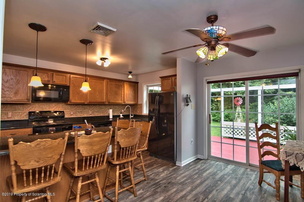 212 Summit Woods Road Moscow, PA 18444 - Photo 11 of 68 a view of a dining room with furniture window and wooden floor