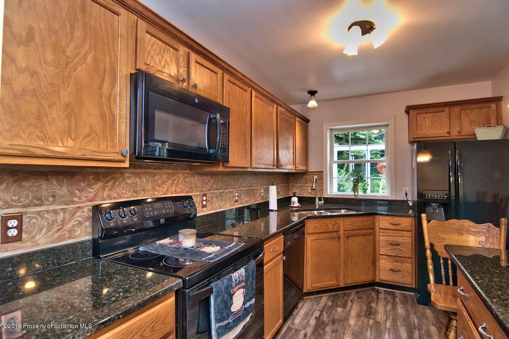 212 Summit Woods Road Moscow, PA 18444 - Photo 19 of 68 a kitchen that has a sink and a stove in it