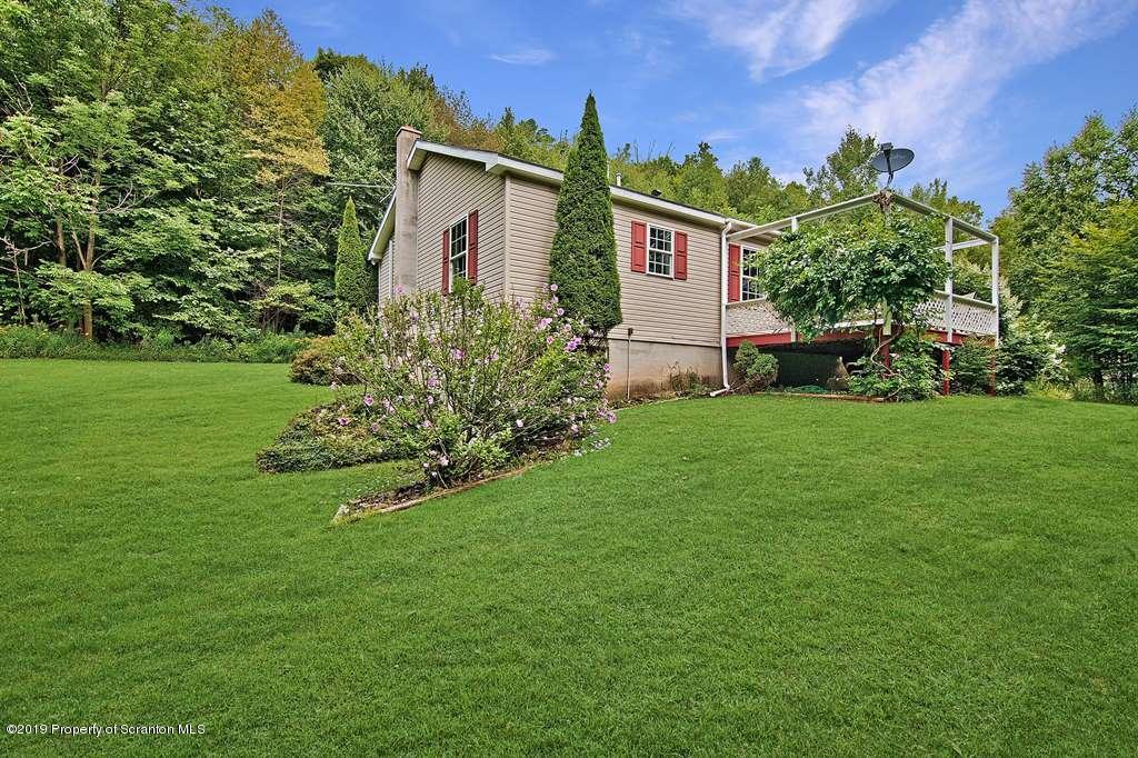 212 Summit Woods Road Moscow, PA 18444 - Photo 2 of 68 a front view of a house with a garden