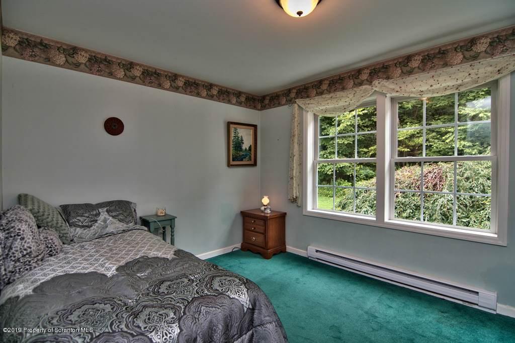 212 Summit Woods Road Moscow, PA 18444 - Photo 23 of 68 a bedroom with a bed and a window