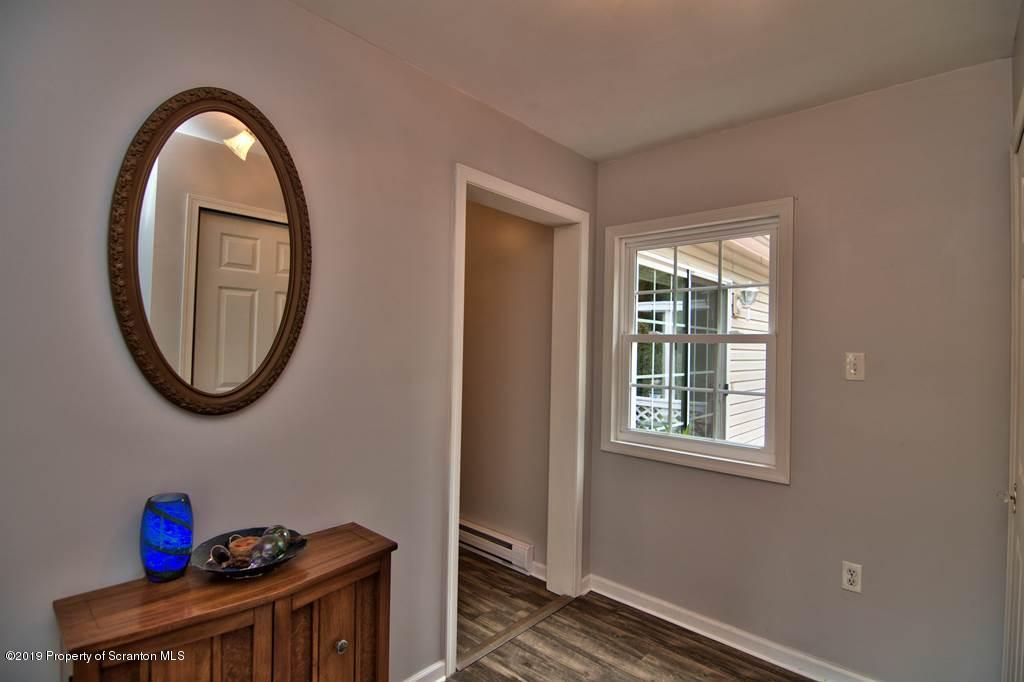 212 Summit Woods Road Moscow, PA 18444 - Photo 31 of 68 a view of a livingroom with wooden floor and a window