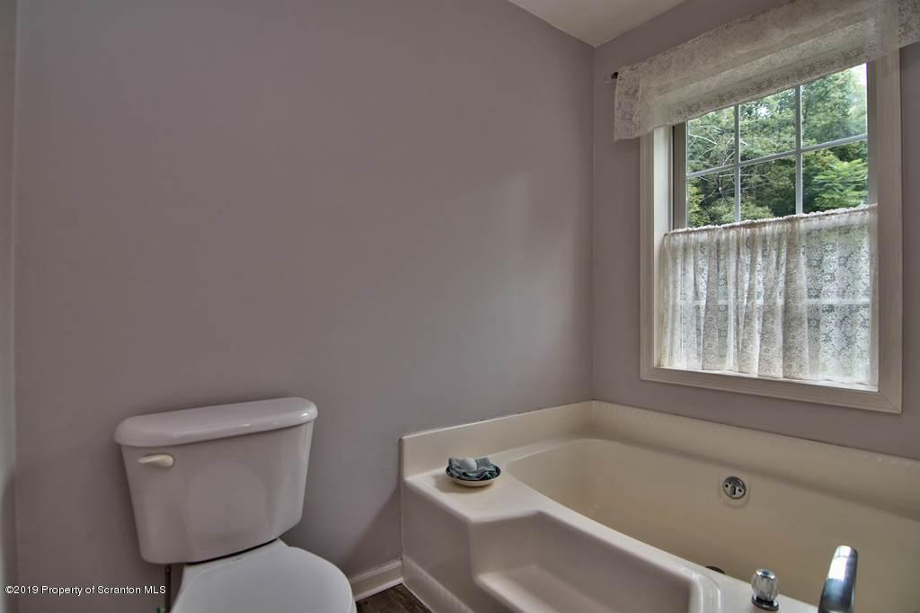 212 Summit Woods Road Moscow, PA 18444 - Photo 36 of 68 a white toilet sitting next to a bath tub