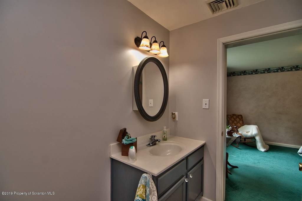 212 Summit Woods Road Moscow, PA 18444 - Photo 39 of 68 a bathroom with a sink and a mirror