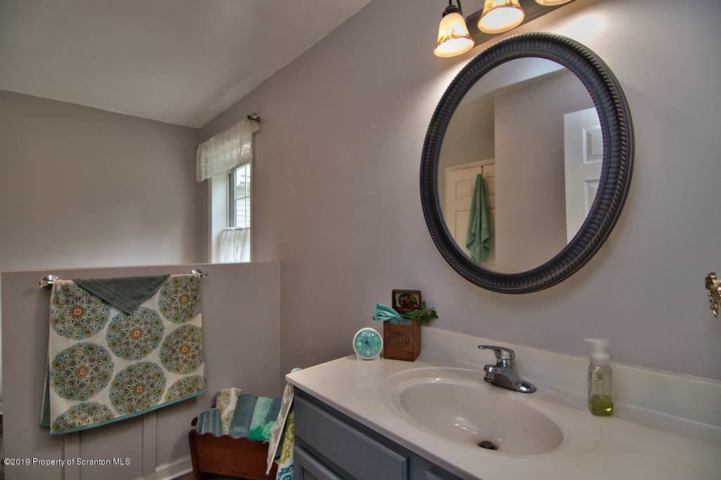 212 Summit Woods Road Moscow, PA 18444 - Photo 40 of 68 a bathroom with a sink and a mirror