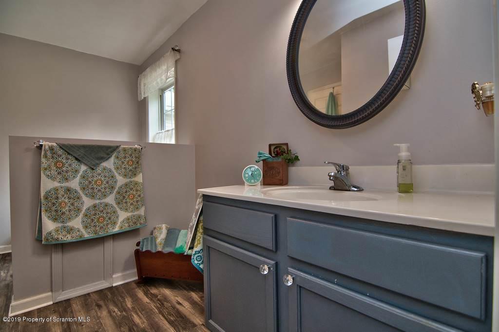 212 Summit Woods Road Moscow, PA 18444 - Photo 41 of 68 a bathroom with a sink and a mirror