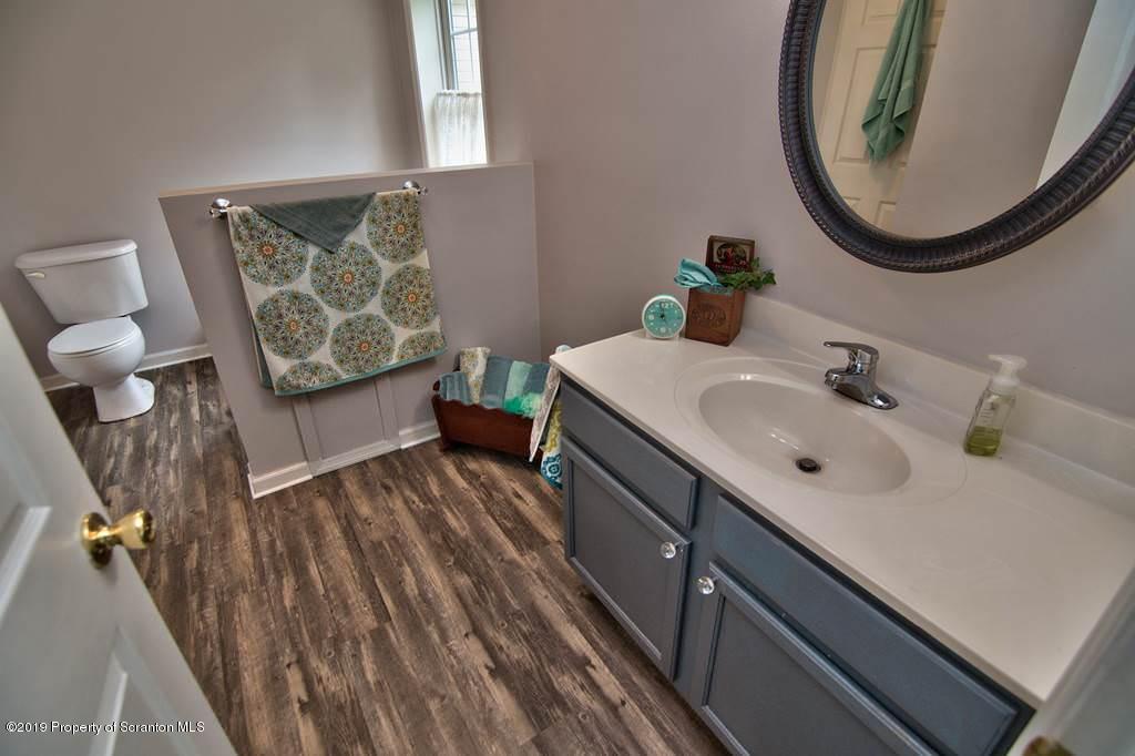 212 Summit Woods Road Moscow, PA 18444 - Photo 42 of 68 a bathroom with a sink and a mirror