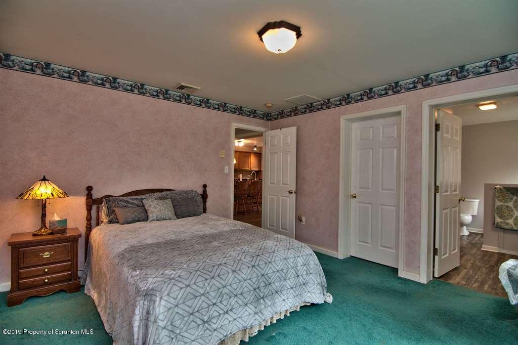 212 Summit Woods Road Moscow, PA 18444 - Photo 47 of 68 a bedroom with a bed and a mirror