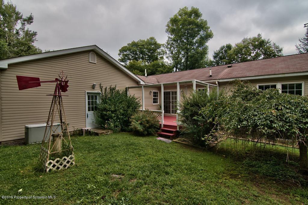 212 Summit Woods Road Moscow, PA 18444 - Photo 53 of 68 a view of a backyard with plants and a garden