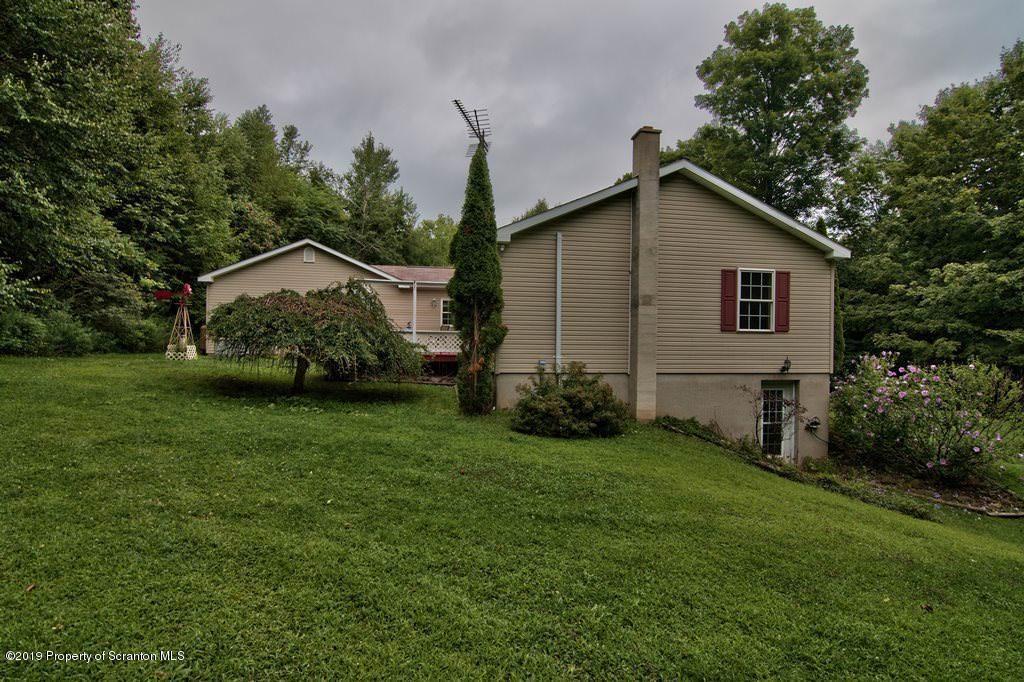 212 Summit Woods Road Moscow, PA 18444 - Photo 55 of 68 a view of a backyard with potted plants and large tree
