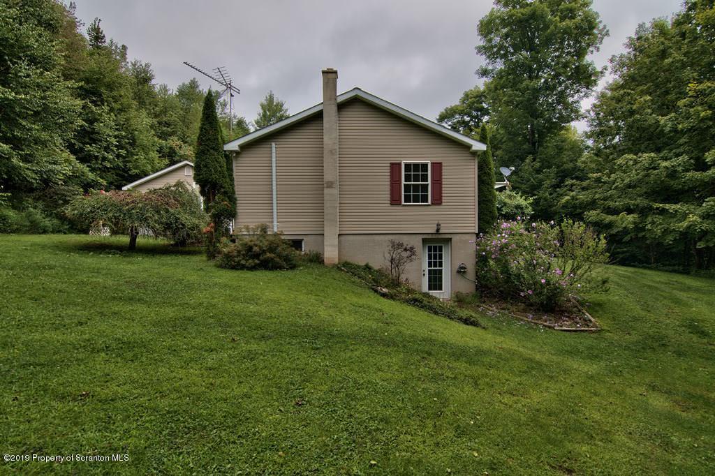 212 Summit Woods Road Moscow, PA 18444 - Photo 56 of 68 a view of a house with a yard and plants